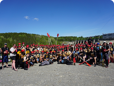 Large group in rafting gear posing for a picture
